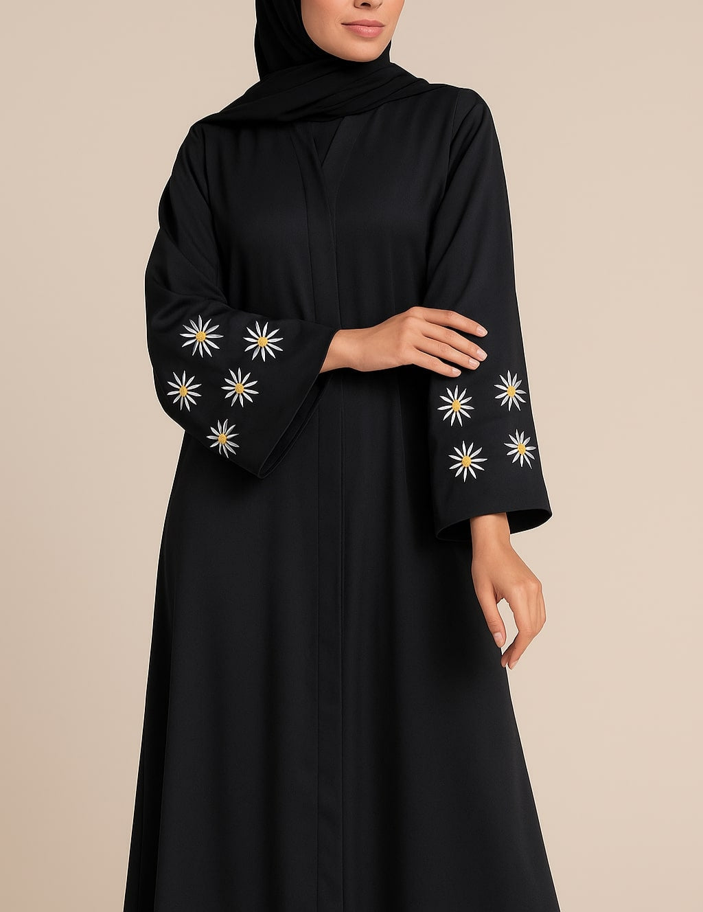 Woman wearing a black abaya with floral embroidery